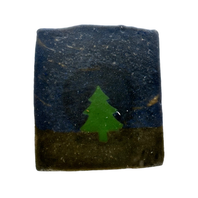 Bar of soap with a green tree design on a white background