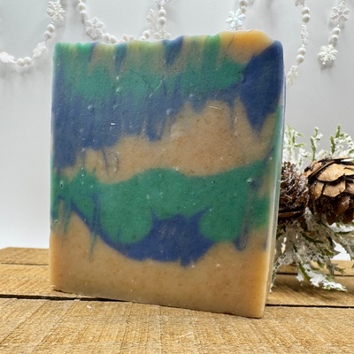 Colorful soap bar on a wooden surface with a white floral background