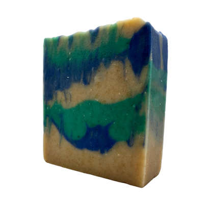 Multicolored soap bar with green, blue, and beige hues on a white background