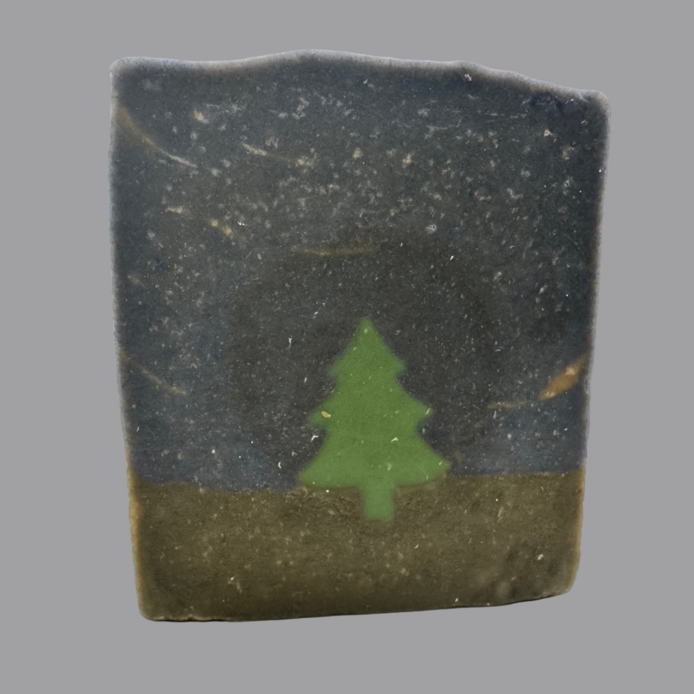 Bar of soap with a green tree design on a white background