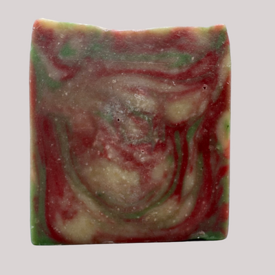 Colorful soap bar with red, green, and beige swirls on a white background
